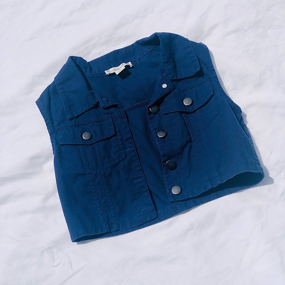 A navy blue vest, size 12, from the brand “knit works”